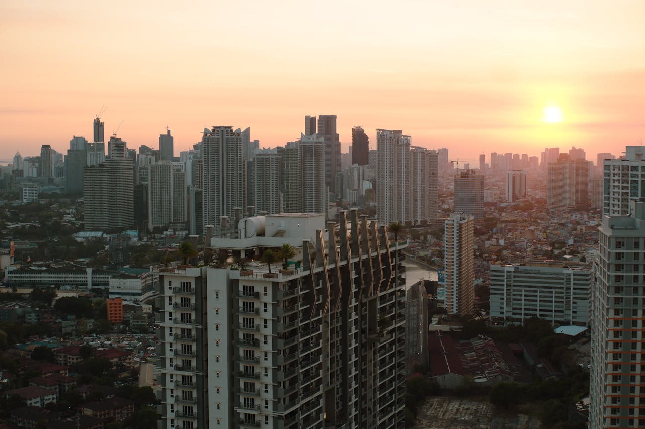 hero-img-02 A breathtaking view of Taguig City skyline with skyscrapers at sunset.