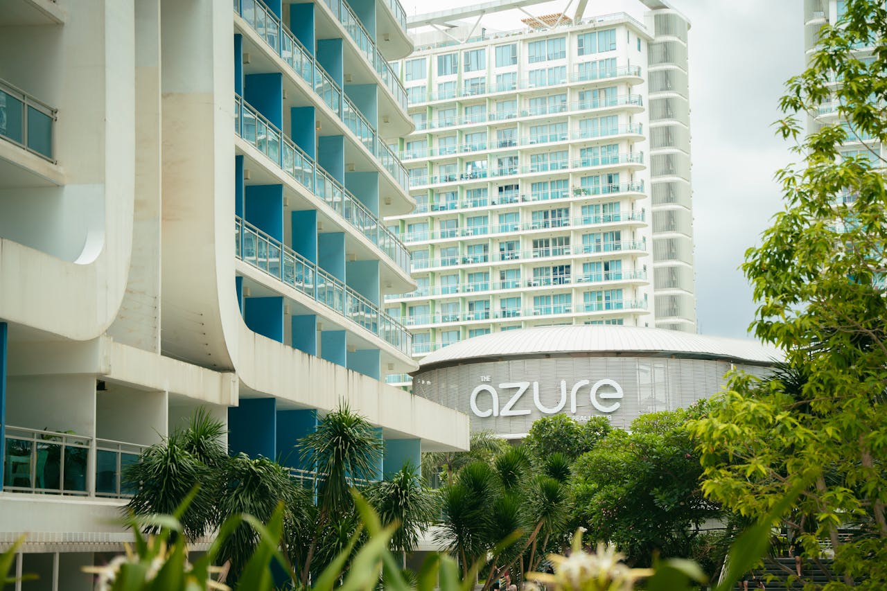 hero-img-01 Contemporary urban architecture featuring balconies and greenery at Azure resort.