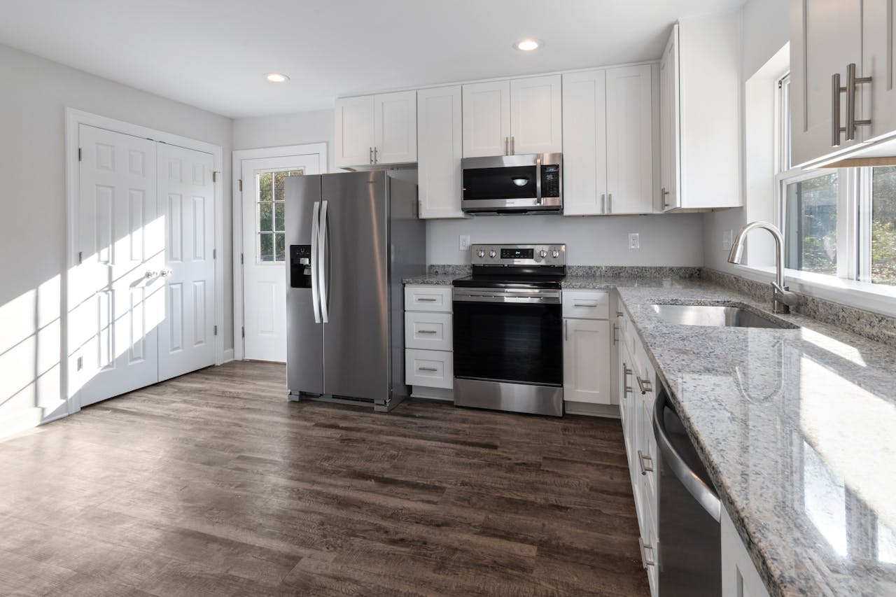 gallery-2 Bright and spacious modern kitchen featuring stainless steel appliances and granite countertops.